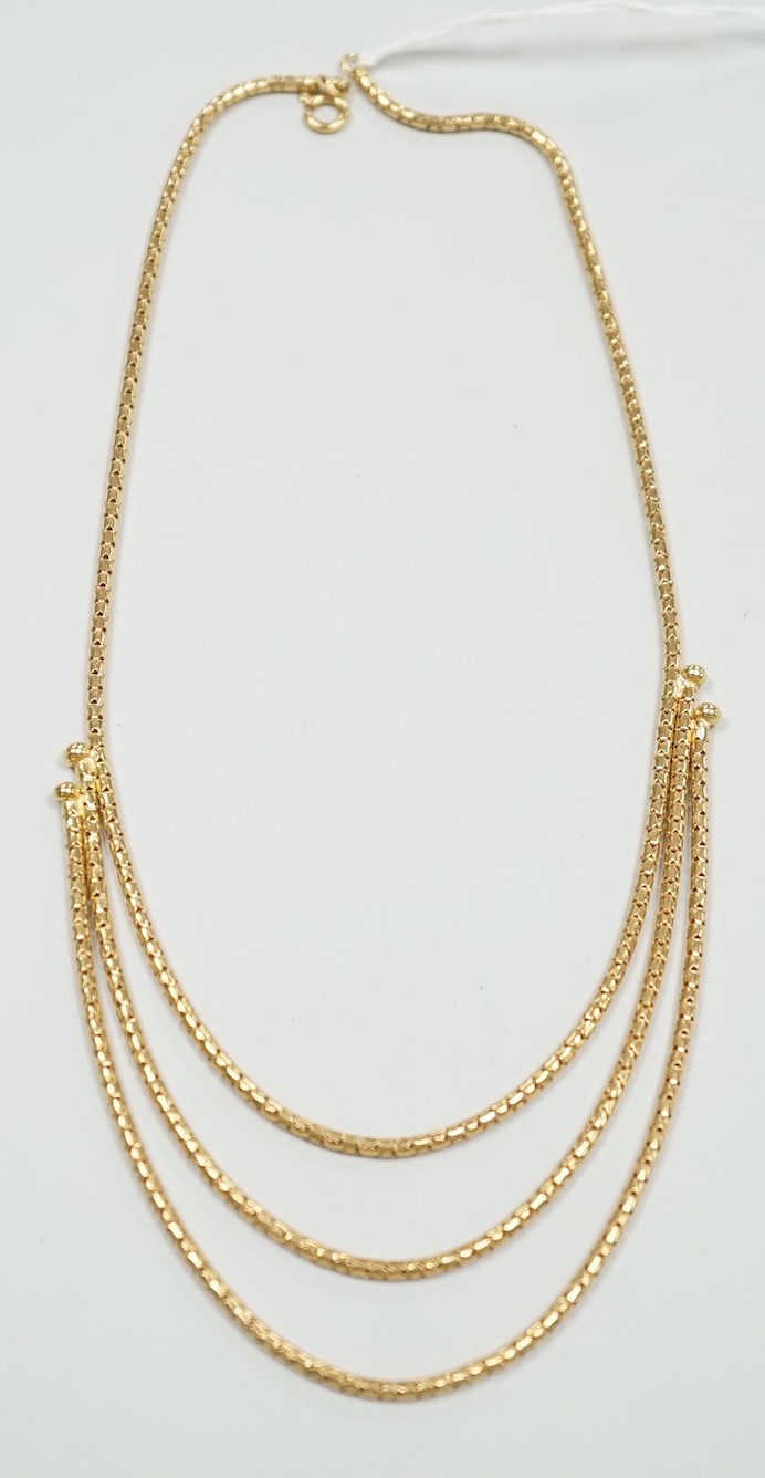 A modern 18ct gold three strand necklace, 43cm, 15.5 grams.